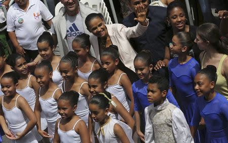 Presidential candidate Marina Silva of Brazilian Socialist Party (PSB) poses with children and people of the Paraisopolis slum as she waves to supporters during her campaign rally in Sao Paulo, in this file picture taken October 1, 2014. REUTERS/Nacho Doce/Files