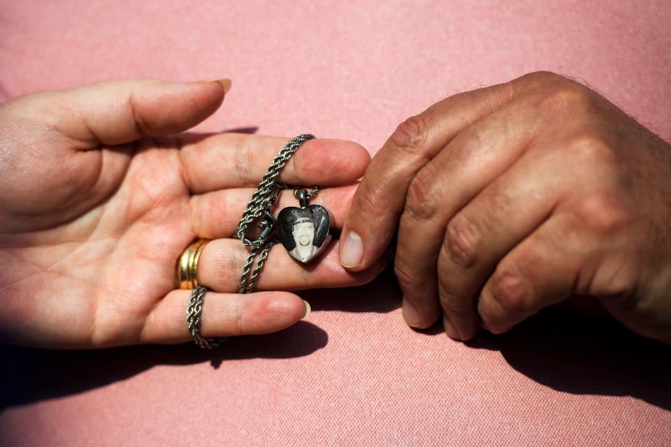 Joanne and Jay Shiflet hold a pendant with the image of Joanne's son, Charles David Carver, after a damages hearing against serial killer Todd Kohlhepp at the Spartanburg County Courthouse Friday, July 26, 2019.