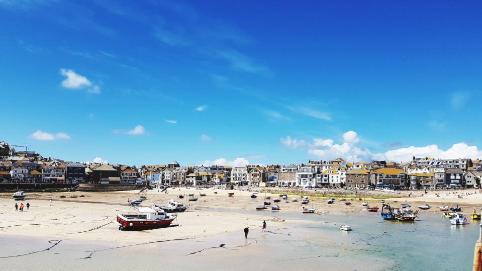 Panoramic View Of People In St Ives Against Blue Sky