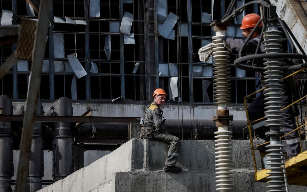 People work at a thermal power plant damaged by a recent Russian missile strike, amid Russia's attack on Ukraine, in an undisclosed location of Ukraine April 8, 2024. REUTERS/Gleb Garanich/File Photo