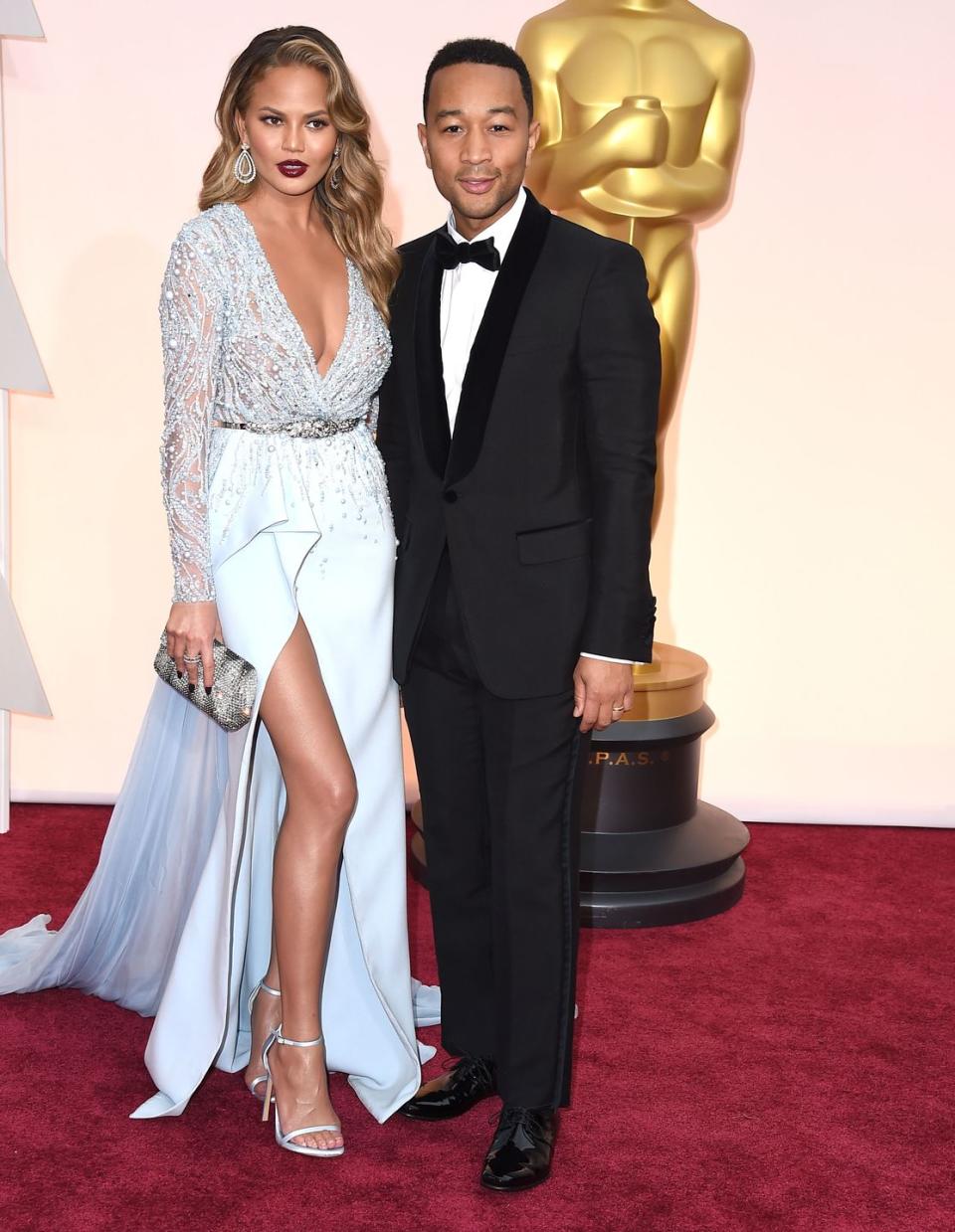 <p>Chrissy Teigen: 5' 9" (taller in heels)<br>John Legend: 5' 9"</p>