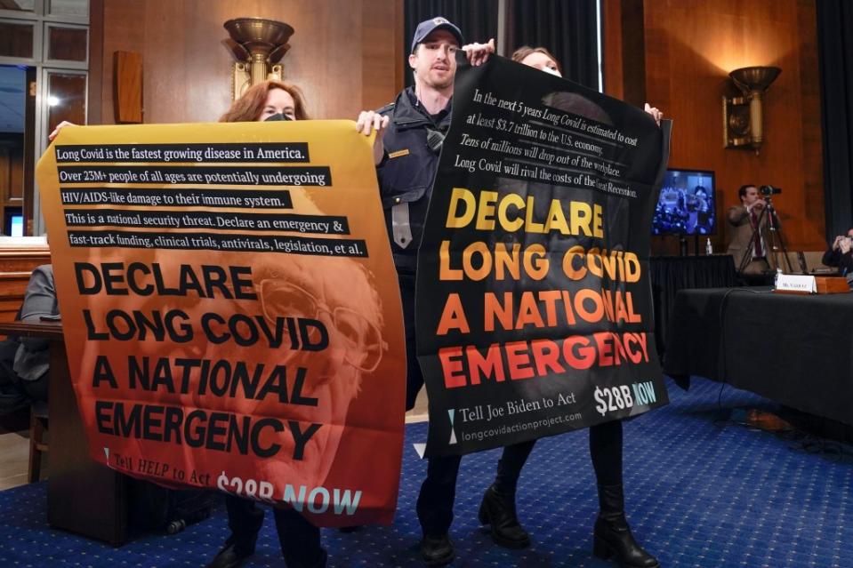 Long COVID occurs when people continue to report symptoms that last for months or even years. Above, protestors gather during a Senate Health, Education, Labor and Pensions hearing to examine long COVID on Capitol Hill in Washington last month. AP