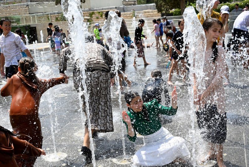 Children cool off in a water fountain near Jerusalem's Old City on August 13 as temperatures reached 102 degrees Fahrenheit during a scorching heat wave in Israel. File Photo by Debbie Hill/UPI