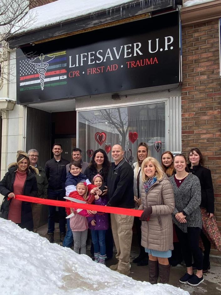 Paul Young cuts the ribbon to open his new first aid training facility, Lifesaver U.P., on Jan. 9, 2023.