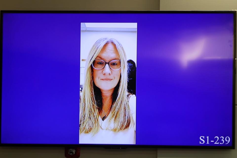 Jeremy Cruz, who is charged with the murder of his wife, Dawn, pictured on the evidence screen in the courtroom, testifies during his trial before Superior Court Judge Jill O'Malley at Monmouth County Courthouse in Freehold, NJ Tuesday, April 23, 2024.