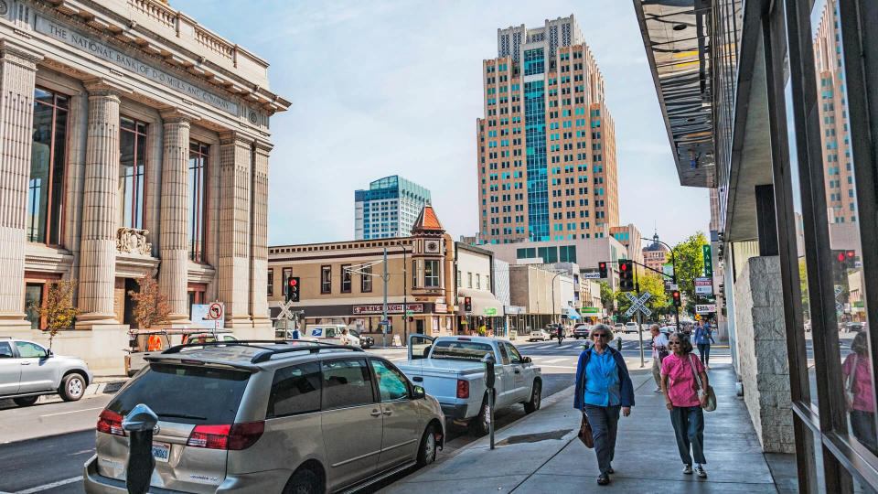 Sacramento, California, USA - September 19, 2017: These two women are walking downtown Sacramento on J Street past historic bank and view with a variety of with many different styles, this downtown area is now being know as DOCO for Downtown Commons many new shops and a hotel and Sports arena and unique older structures in the area on this September day the weather was comfortable.