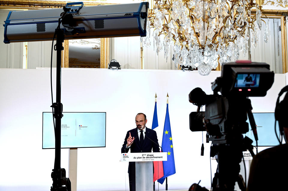 French Prime Minister Edouard Philippe speaks during a televised address next to a screen showing the future in Paris Thursday, May 28, 2020. France is reopening its restaurants, bars and cafes starting next week as the country eases most restrictions amid the coronavirus crisis. Edouard Philippe defended the gradual lifting of lockdown up to now, saying the strategy was meant to avoid provoking a second wave. (Philippe Lopez, Pool via AP)