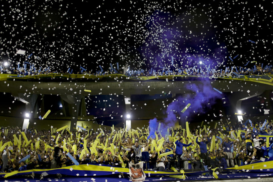 Fans of Boca Juniors cheer amid confetti during the Copa Libertadores semifinal second leg soccer match against River Plate at La Bombonera stadium in Buenos Aires, Argentina, Tuesday, Oct. 22, 2019. (AP Photo/Natacha Pisarenko)