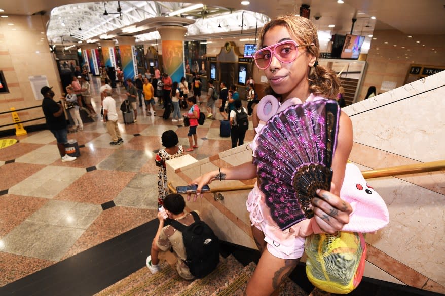 person holding fan in PENN station