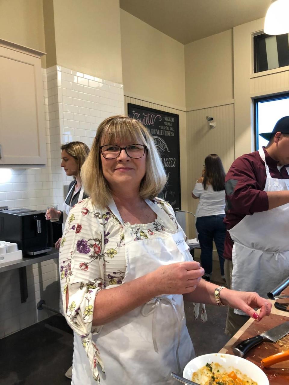 Kathryn Bitner Bryan, 64, was an innocent bystander killed in a shooting in Burleson, according to police. In this photo provided by her family, she was at a cooking class.