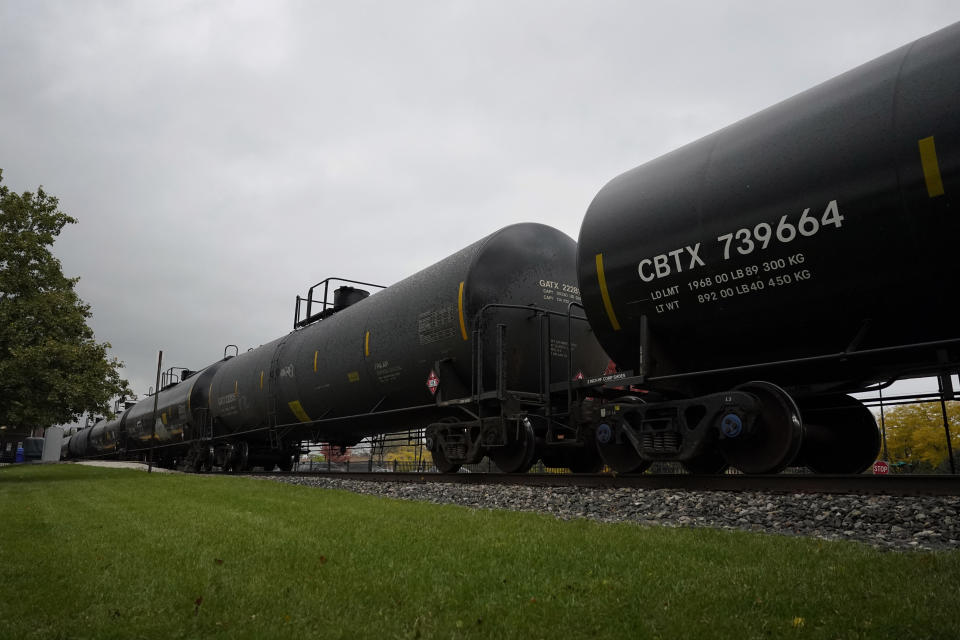 Freight train is seen at a train station in Northbrook, Ill., Wednesday, Oct. 12, 2022. A fifth rail union has approved its deal with the freight railroads to secure 24% raises and $5,000 in bonuses and a sixth one is set to vote Thursday. But all 12 rail unions must ratify their contracts to prevent a strike. (AP Photo/Nam Y. Huh)