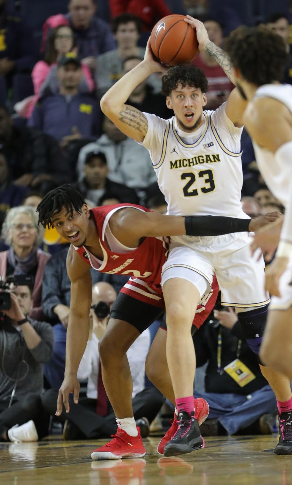 Michigan forward Brandon Johns Jr. rebounds against Wisconsin forward Aleem Ford during the first half Thursday, Feb. 27, 2020 at the Crisler Center in Ann Arbor.