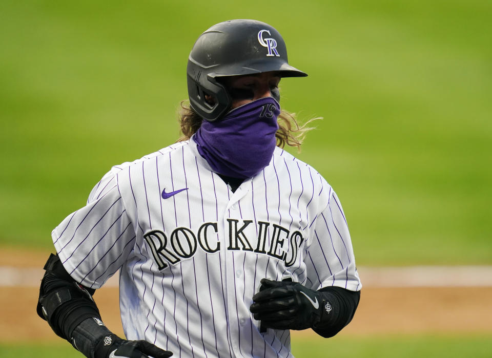 Colorado Rockies' Charlie Blackmon celebrates a run scored against the San Francisco Giants during the fourth inning of a baseball game, Tuesday, Aug. 4, 2020, in Denver. (AP Photo/Jack Dempsey)