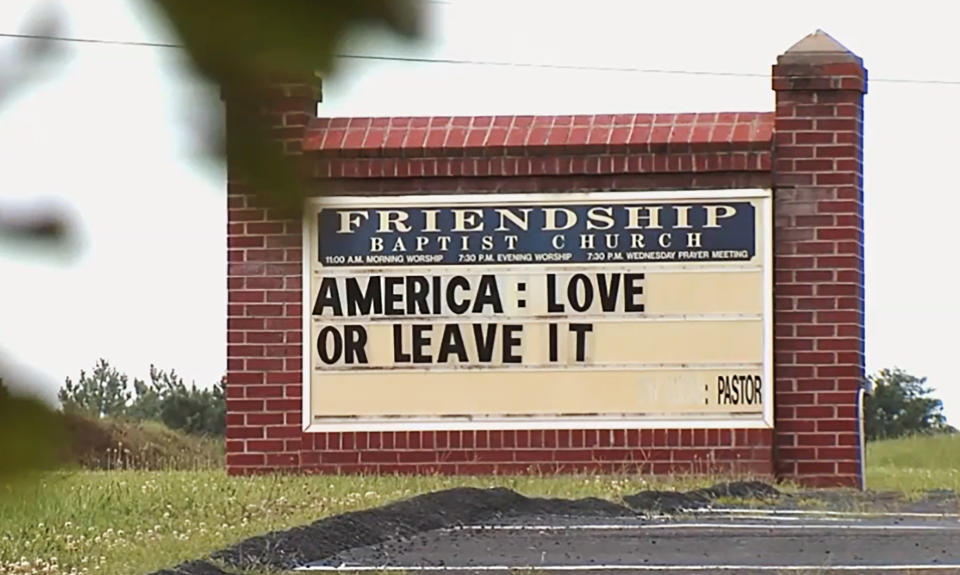 FILE - This Tuesday, July 16, 2019 image from video provided by WSET-TV shows a sign for the Friendship Baptist Church which reads, "America: Love it or Leave It" in Appomattox, Va. Amid a national furor over President Donald Trump’s tweet urging four Democratic congresswomen to “go back” to their home countries, Pastor E. W. Lucas is gaining attention with the sign at his church. (WSET-TV via AP)