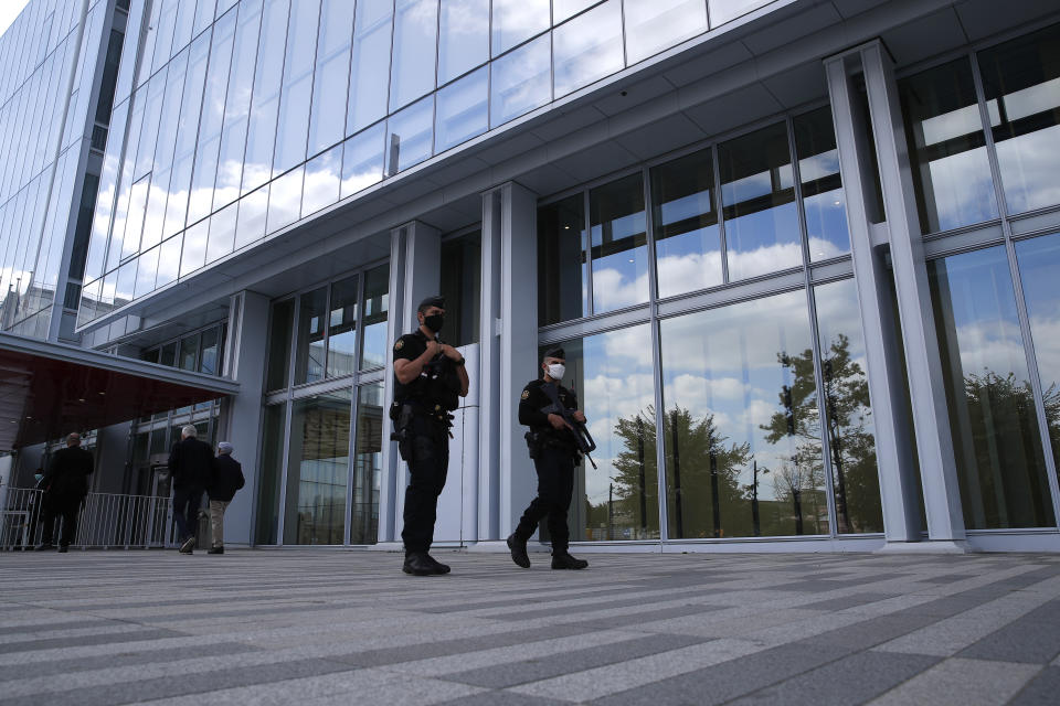 Police officers patrol outside the Paris courthouse during the opening of the 2015 attacks trial, Wednesday, Sept. 2, 2020 in Paris. Thirteen men and a woman go on trial Wednesday over the 2015 attacks against a satirical newspaper and a kosher supermarket in Paris that marked the beginning of a wave of violence by the Islamic State group in Europe. Seventeen people and all three gunmen died during the three days of attacks in January 2015. (AP Photo/Francois Mori)