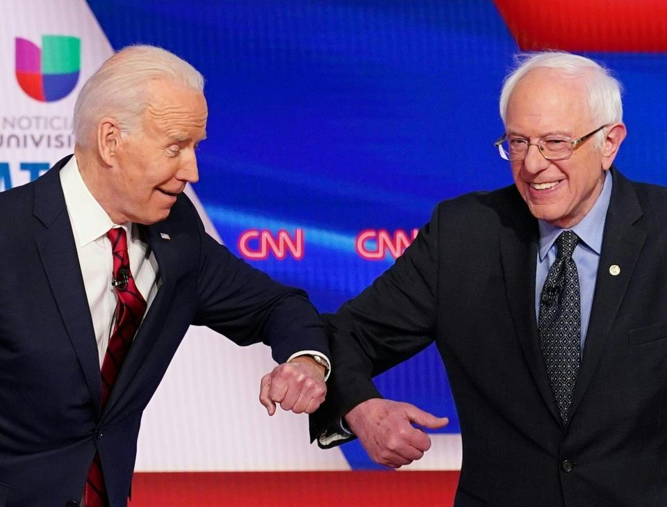 Democratic presidential hopefuls former US vice president Joe Biden (L) and Senator Bernie Sanders greet each other with a safe elbow bump before the start of the 11th Democratic Party 2020 presidential debate in a CNN Washington Bureau studio in Washington, DC on March 15, 2020. (Mandel Ngan/AFP via Getty Images)