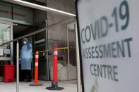 FILE PHOTO: A nurse guides people being tested for coronavirus disease (COVID-19) outside a hospital in Toronto