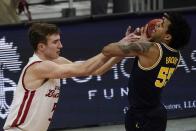 Michigan's Eli Brooks tries to grab a rebound in front of Wisconsin's Tyler Wahl during the second half of an NCAA college basketball game Sunday, Feb. 14, 2021, in Madison, Wis. (AP Photo/Morry Gash)