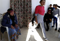 Gamra, the mother of the Nice attacker Ibrahim Issaoui, left, adresses reporters in Sfax, Tunisia, Friday, Oct. 30, 2020. The family of Ibrahim Issaoui expressed shock after he attacked a church in Nice and killed three people in what French and Tunisian authorities are investigating as a terrorist attack. Tunisian prosecutors say he had not been on their radar for radicalization before he fled with other migrants to the Italian island of Lampedusa in September, eventually making his way to Nice. (AP Photo/Helmy Ben Salah)