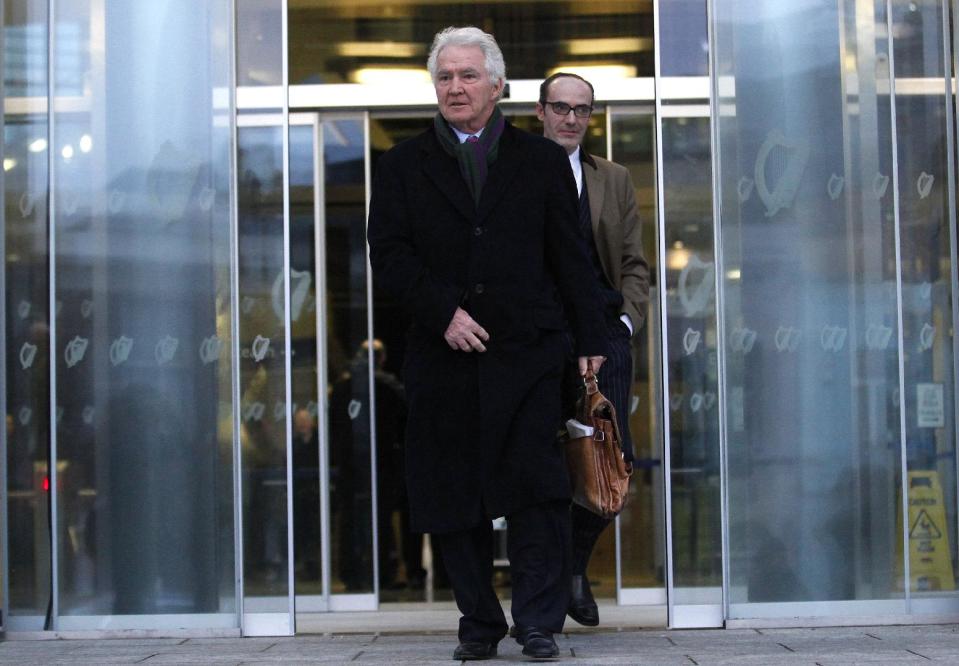 FILE - In this Wednesday, Feb. 5, 2014, file photo former chairman and chief executive of Anglo Irish Bank Sean FitzPatrick leaves Dublin Criminal Court, Ireland. FitzPatrick is charged along with two other former Anglo Irish Bank members with trying to inflate the share price. The judge overseeing the 10-week-old trial issued surprise acquittal instructions to jurors Wednesday, April 9, 2014, after prosecutors finished their case against Sean FitzPatrick, Pat Whelan and Willie McAteer. Their defense starts this week. The judge dropped six charges against Anglo’s former chairman FitzPatrick and seven charges against former lending director Whelan. The three men still face 42 charges of secretly lending more than 500 million euros ($700 million) to top clients for them to buy Anglo’s sagging shares in 2008. (AP Photo/Peter Morrison, File)