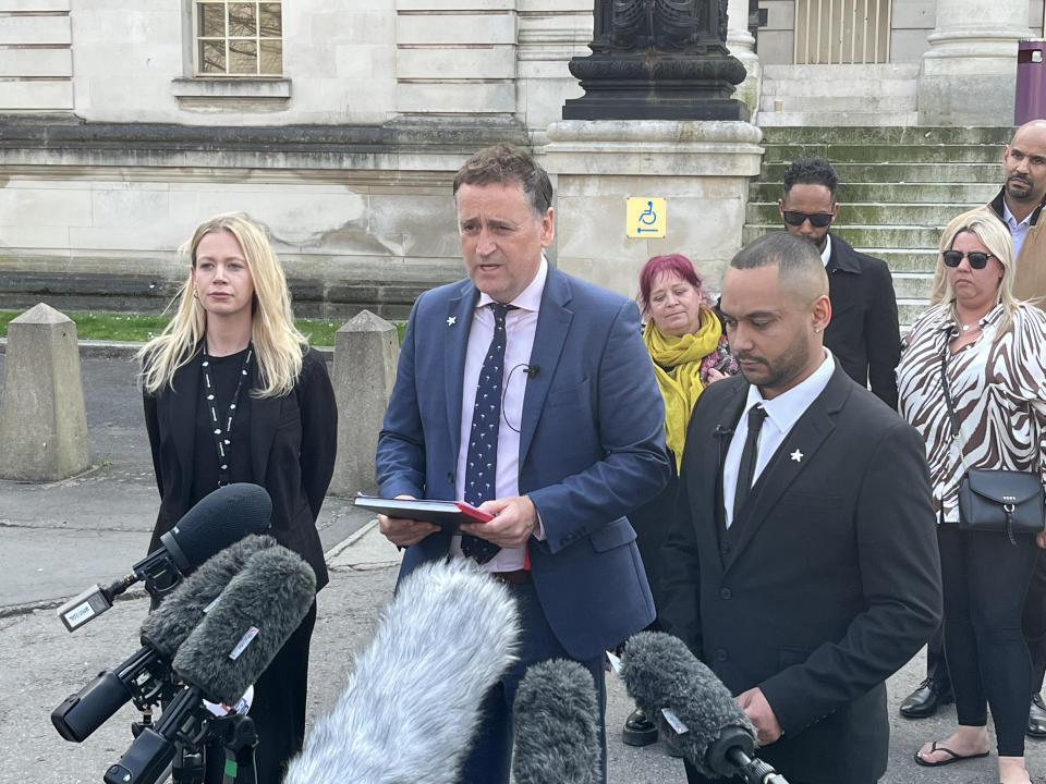 Detective Superintendent Darren George (centre), of South Wales Police, reads a statement outside Cardiff Crown Court alongside Ben Mwangi after John Cole, Angharad Williamson and a 14-year-old boy were found guilty of the murder of five-year-old Logan Mwangi. Picture date: Thursday April 21, 2022.