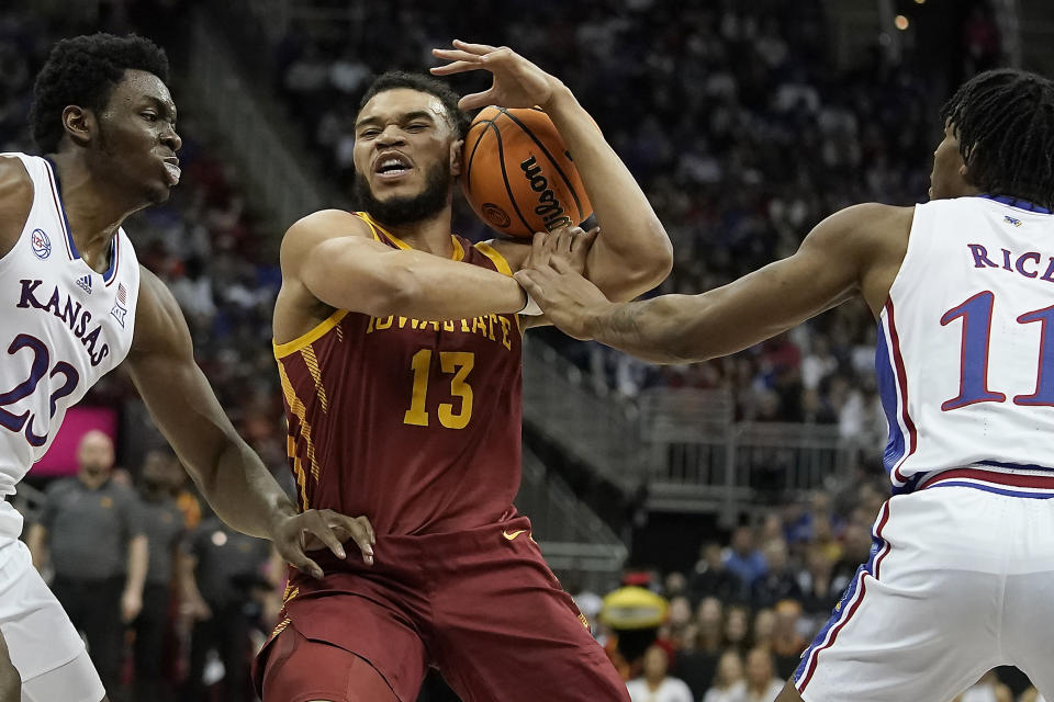 Kansas center Ernest Udeh Jr. (23) and guard MJ Rice (11) pressure Iowa State guard Jaren Holmes (13) during the first half of an NCAA college basketball game in the semifinal round of the Big 12 Conference tournament Friday, March 10, 2023, in Kansas City, Mo. (AP Photo/Charlie Riedel)