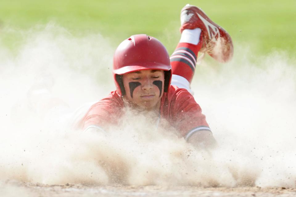Cranston West's Chris Piscione slides safely into home plate during the third inning of Wednesday's Division I win over Toll Gate.