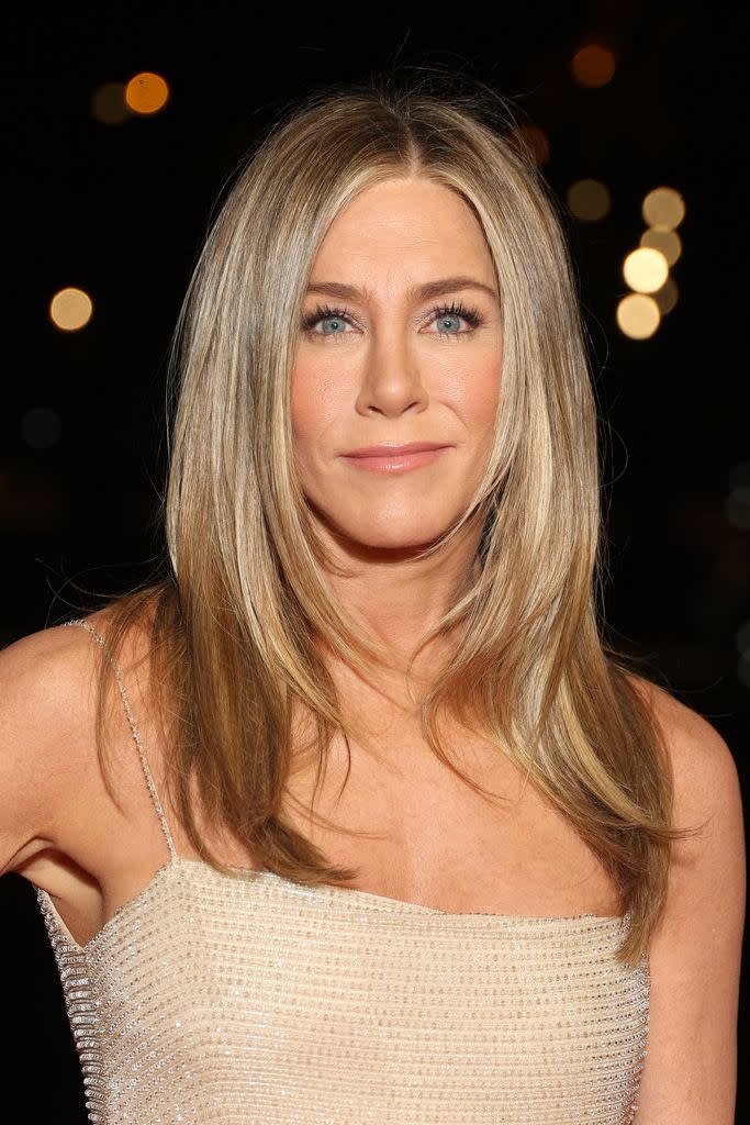 jennifer aniston in gold dress with shiny hair
