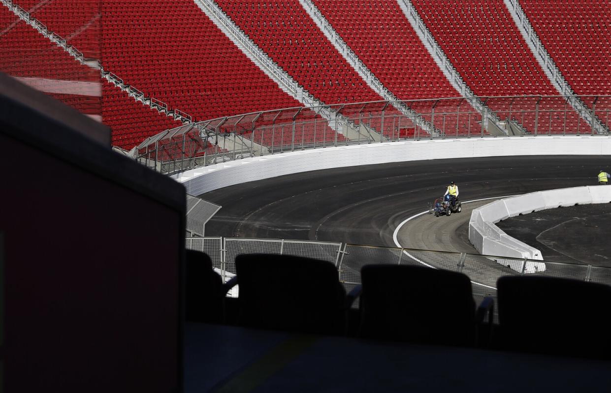 Lane lines are painted ahead of the NASCAR race at the Coliseum.