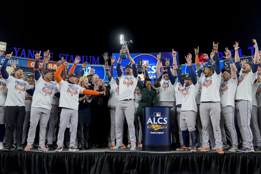 The Houston Astros celebrate with the American League Championship trophy after defeating the New York Yankees in Game 4