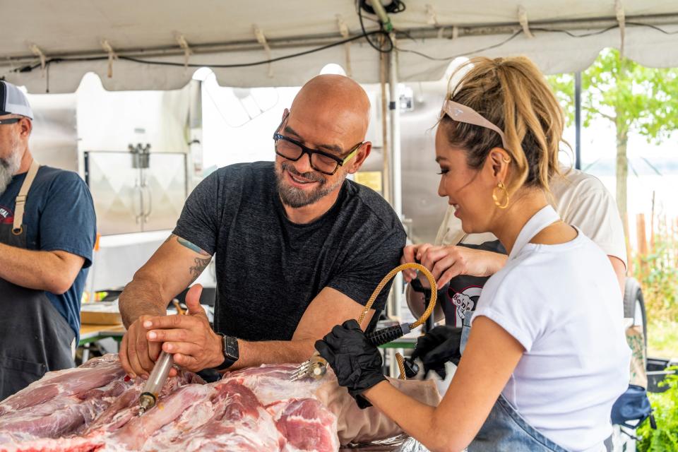 Celebrity chef Michael Symon works with the Bone Thugs and BBQ team during the Memphis In May World Championship Barbecue Cooking Contest, as seen on an episode of "BBQ USA."