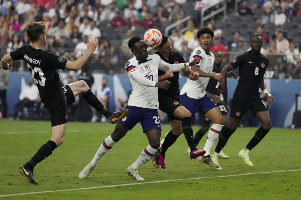 Folarin Balogun of the United States, center left, and Stephen Eustaquio, of Canada, center right, battle for the ball during the first half of a CONCACAF Nations League final match Sunday, June 18, 2023, in Las Vegas. (AP Photo/John Locher)