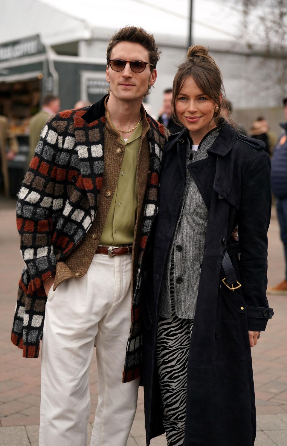 Oliver Proudlock and Emma Louise Connolly arriving for day two of the 2024 Cheltenham Festival at Cheltenham Racecourse. Picture date: Wednesday March 13, 2024.