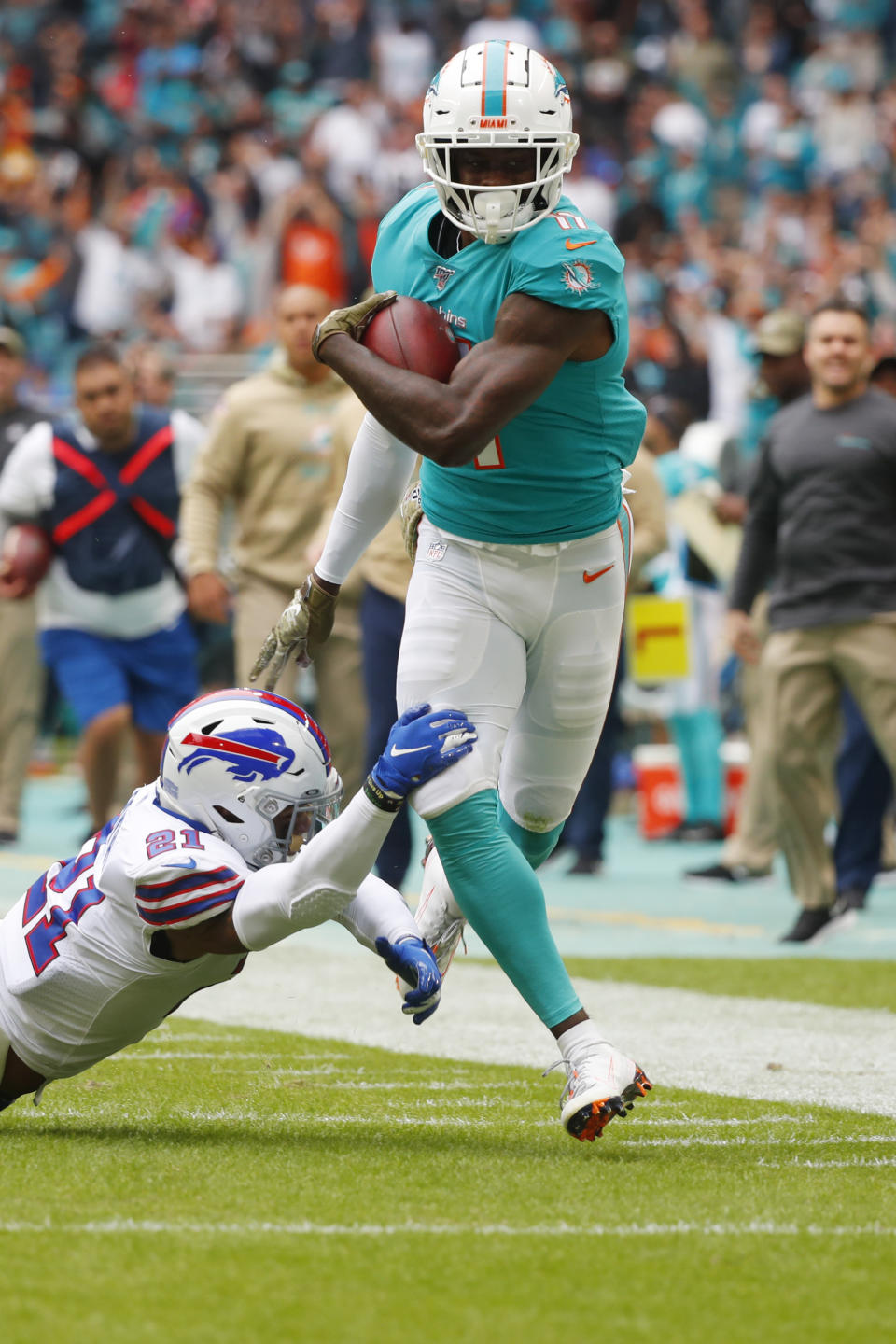 Buffalo Bills free safety Jordan Poyer (21) takes a hold of Miami Dolphins wide receiver DeVante Parker (11), during the first half at an NFL football game, Sunday, Nov. 17, 2019, in Miami Gardens, Fla. (AP Photo/Wilfredo Lee)