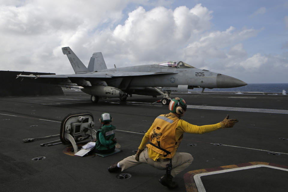 An F/A-18 Super Hornet fighter jet prepares to takes off on the deck of the U.S. Navy USS Ronald Reagan in the South China Sea, Tuesday, Nov. 20, 2018. China is allowing a U.S. Navy aircraft carrier and its battle group to make a port call in Hong Kong after it turned down similar request amid tensions with Washington. (AP Photo/Kin Cheung)