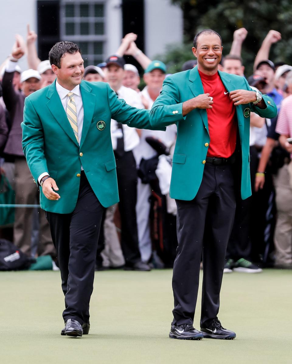 Tiger Woods, getting help with his green jacket from Patrick Reed in 2019, won another Masters on his way to besting Jack Nicklaus' grand slam record.