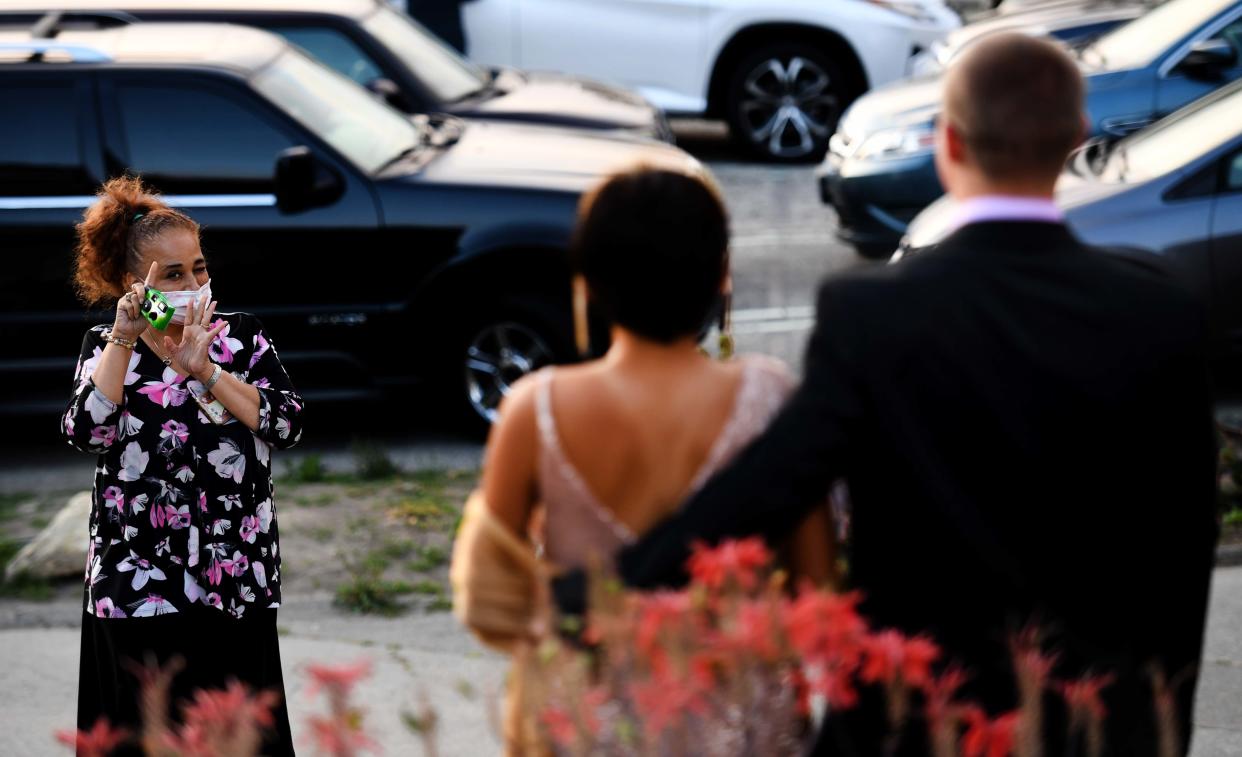 Marta Nguyen prepares to take a picture of her daughter Nina Nguyen and prom date Aidan Musgrave