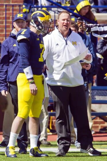 Michigan quarterback Shane Morris (7) listens to direction from offensive coordinator Tim Drevno