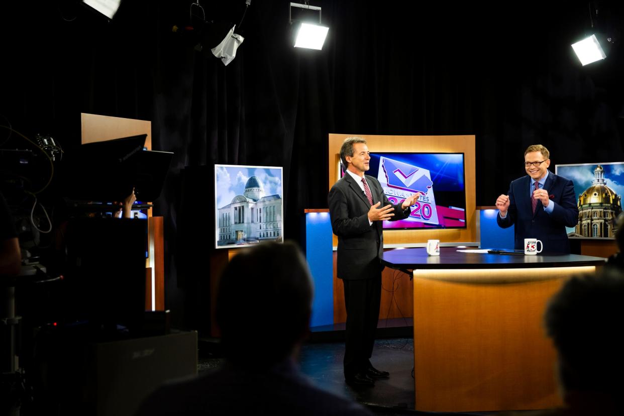 Montana Governor and 2020 Democratic presidential candidate Steve Bullock, left, and WHO's Dave Price laugh before a televised town hall meeting at WHO in 2019 in Des Moines.