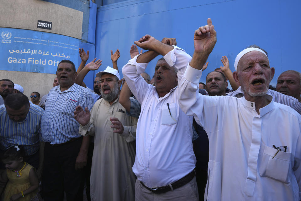 Palestinian demonstrators chant slogans in front of the gate of the United Nations Relief and Works Agency (UNRWA), demanding that the agency fulfil promises to compensate them for losses to their homes during the 2014 war, in Gaza City, Thursday, Sept. 7, 2023. The protest revealed public desperation amid ongoing efforts to alleviate Gaza's housing crisis, including an Egyptian-funded project that aims to complete 1,400 apartments by the end of this year. (AP Photo/Adel Hana)
