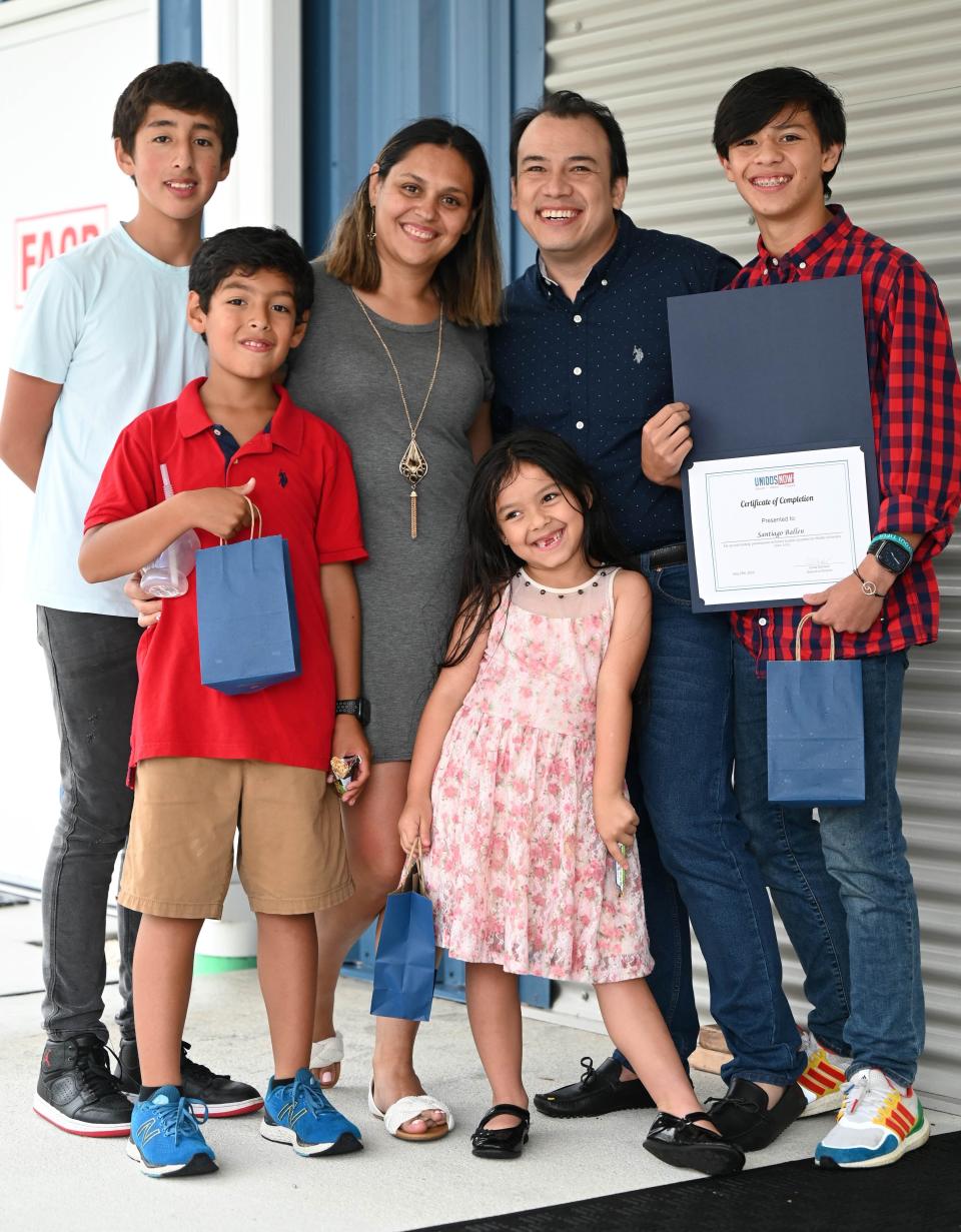 Santiago B., right, a Future Leaders Academy for Middle School graduate, celebrates with family.