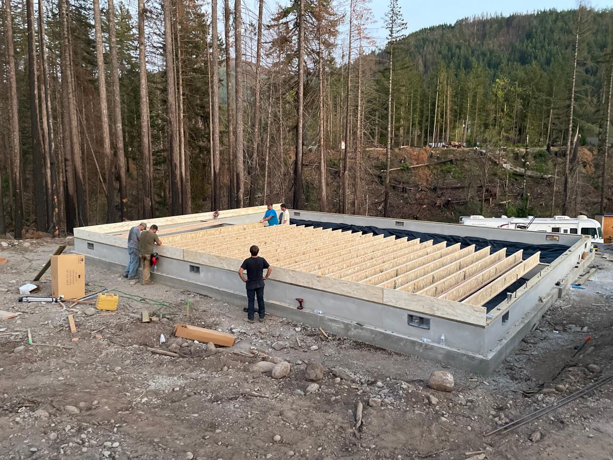 Workers pour the foundation of a house in the Santiam Canyon.