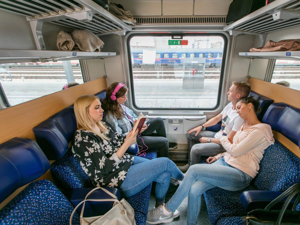 People in a couchette accommodation on a Nightjet train.