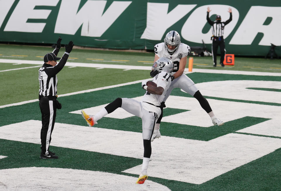 EAST RUTHERFORD, NEW JERSEY - DECEMBER 06: Hunter Renfrow #13 of the Las Vegas Raiders celebrates with Henry Ruggs III #11 after his touchdown to win the game during the second half against the New York Jets at MetLife Stadium on December 06, 2020 in East Rutherford, New Jersey. The Las Vegas Raiders won 31-28. (Photo by Al Bello/Getty Images)