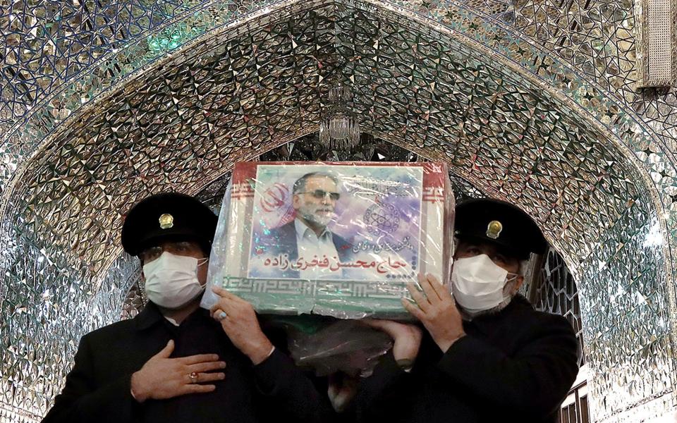 The coffin of Iranian nuclear scientist Mohsen Fakhrizadeh is carried through a shrine in Mashhad, Iran - WANA NEWS AGENCY /VIA REUTERS 