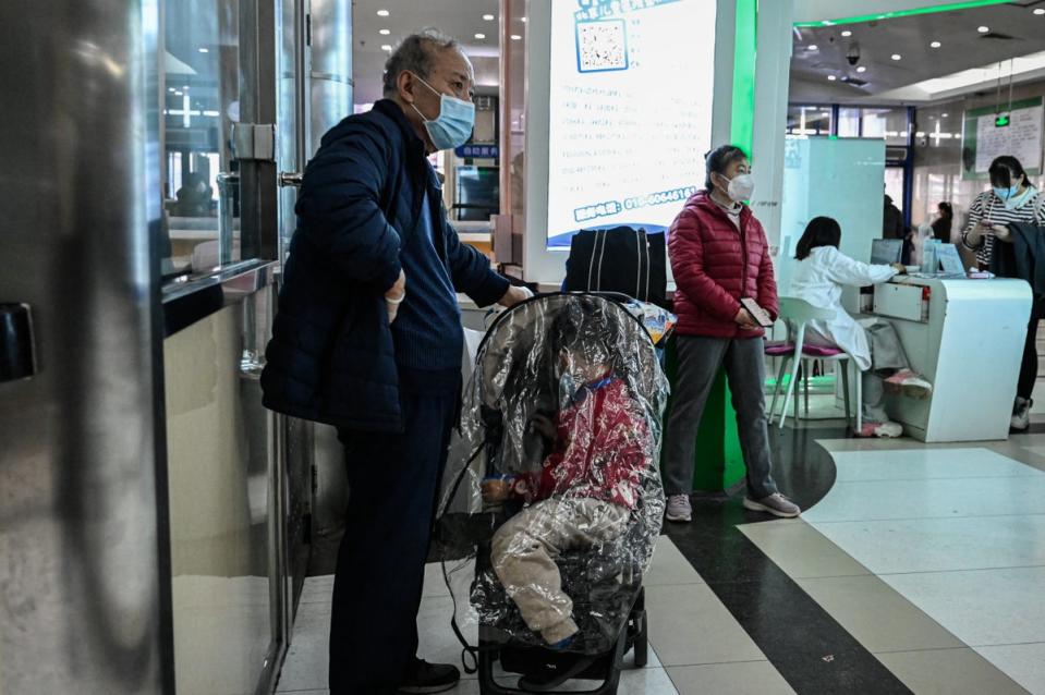 Children and their parents wait at an outpatient area at a children hospital in Beijing (AFP via Getty Images)