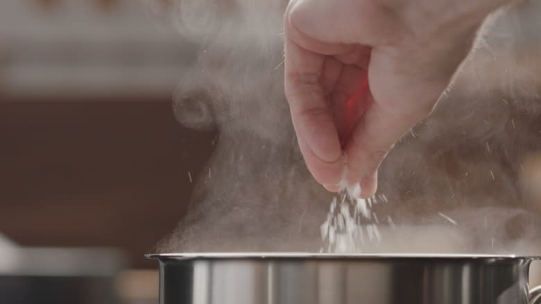 Salting water in steaming pot