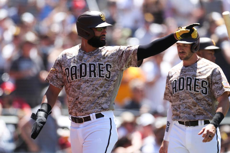 San Diego Padres' Nomar Mazara gestures toward second base after scoring on a double by C.J. Abrams against the Philadelphia Phillies in the third inning of a baseball game Sunday, June 26, 2022, in San Diego. (AP Photo/Derrick Tuskan)