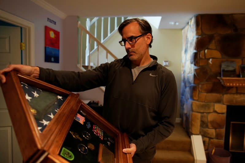 Mark Giaconia, who served for 20 years in the U.S. Army, of which 15 years in the U.S. Special Forces and was embedded with the Kurds in Iraq, shows his medals at his house in Herndon