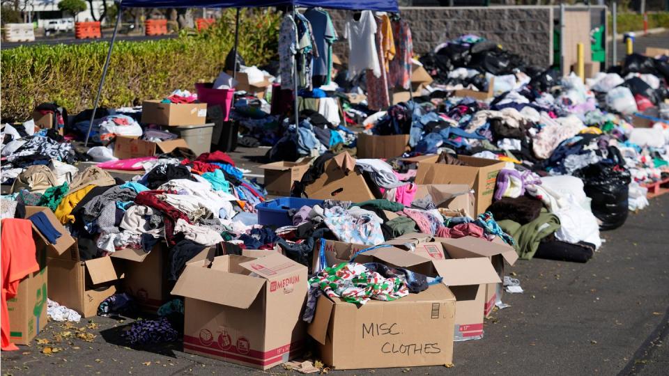 Gespendete Kleidung wird in Lahaina, Hawaii, auf einem Parkplatz gesammelt, nachdem die Waldbrände schwere Schäden verursacht haben. (Bild: Rick Bowmer/AP/dpa)